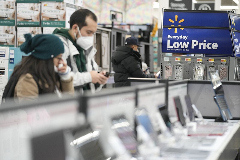 Shoppers check out the electronic devices for sale at a Walmart in Secaucus, N.J., on Nov. 22. Inflation in October showed signs of slowing but remained stubbornly rapid according to economic data from the Commerce Department released Thursday.
(AP/Seth Wenig)