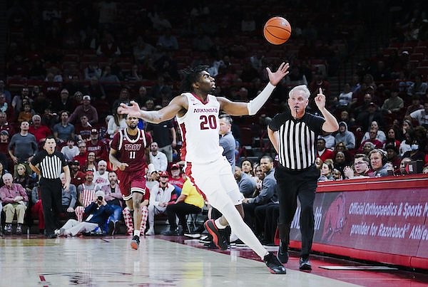 Arkansas forward Kamani Johnson (20) chases a loose ball during a game against Troy on Monday, Nov. 28, 2022, in Fayetteville.