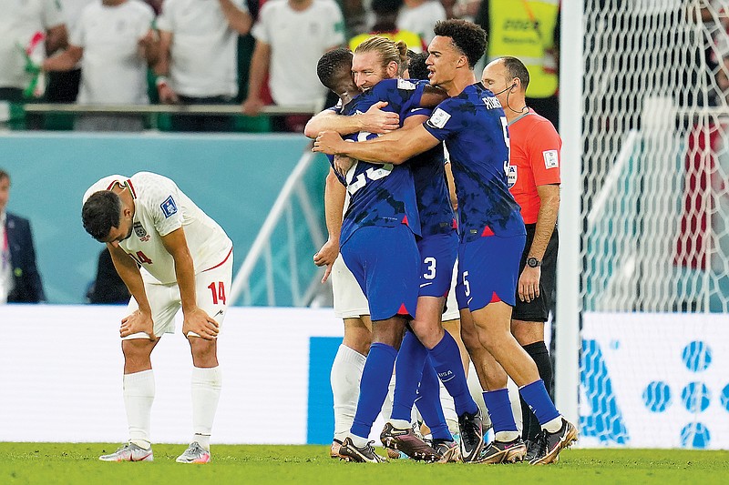 U.S players celebrate after Tuesday’s win in a World Cup Group B match against Iran in Doha, Qatar. (Associated Press)