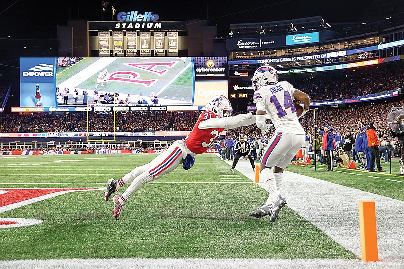 Bills wide receiver Stefon Diggs scores a touchdown while defended by Patriots cornerback Jonathan Jones during Thursday night's game in Foxborough, Mass. (Associated Press)