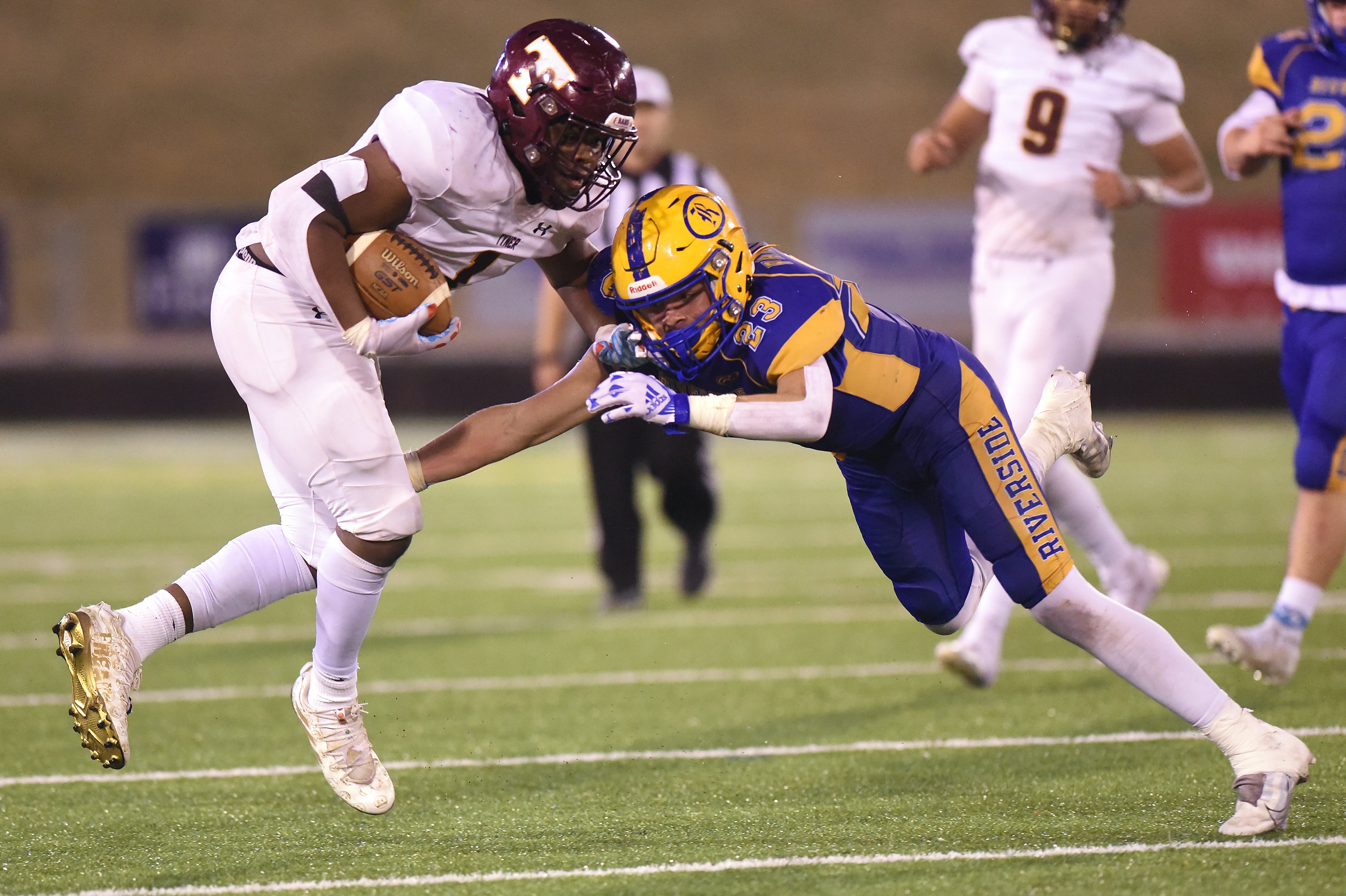 Staff Photo by Matt Hamilton / Tyner (1) Jersey Chubb evades Riverside (23) Jagger Cupples as he carries the ball after a catch during the Class 2A BlueCross Bowl state championship game at Finley Stadium on Saturday, December 3, 2022.