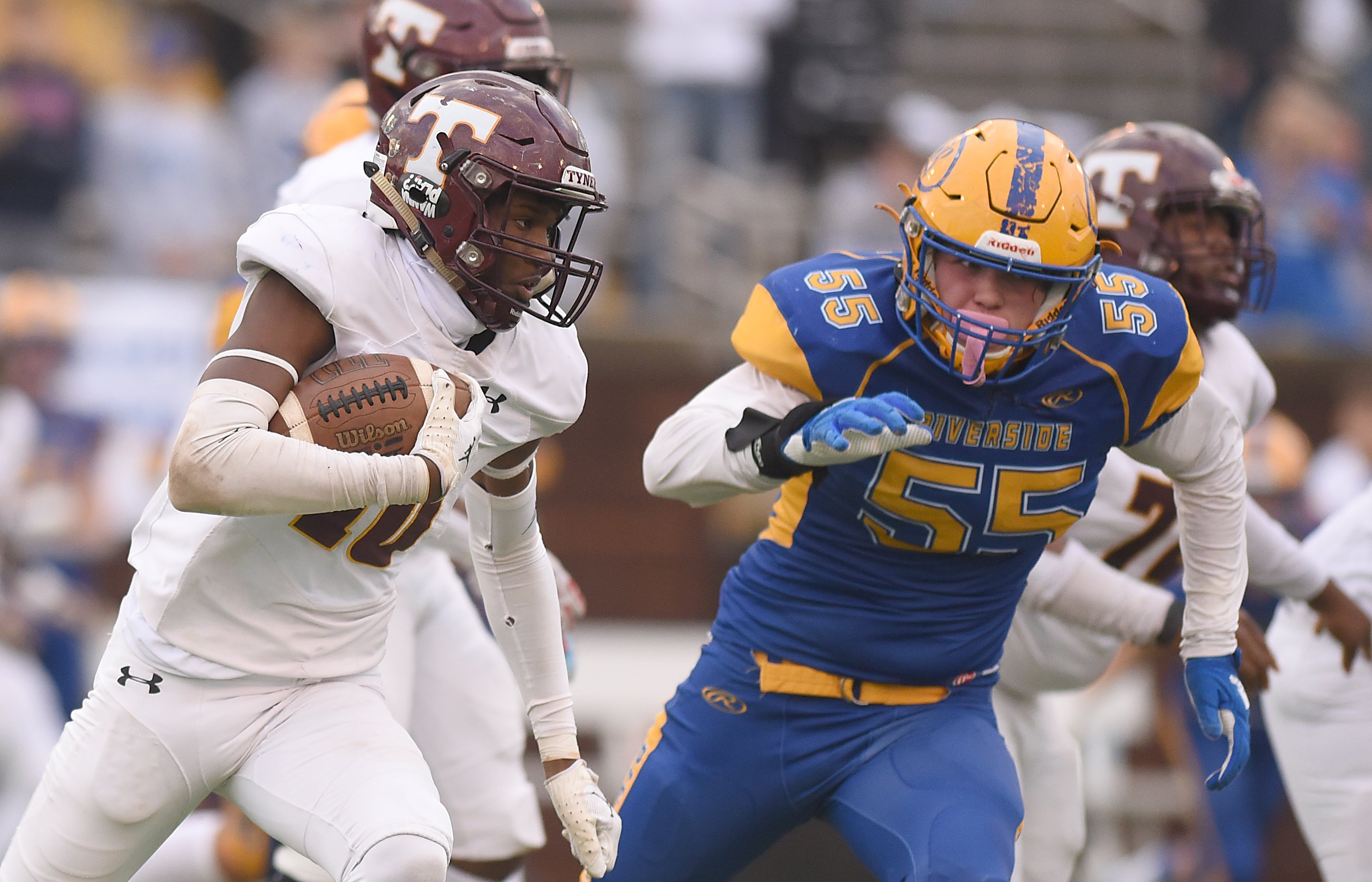Staff Photo by Matt Hamilton / Riverside (55) Ty Hernandez chases Tyner (10) McKinley Markel as he carries the ball during the Class 2A BlueCross Bowl state championship game at Finley Stadium on Saturday, December 3, 2022.