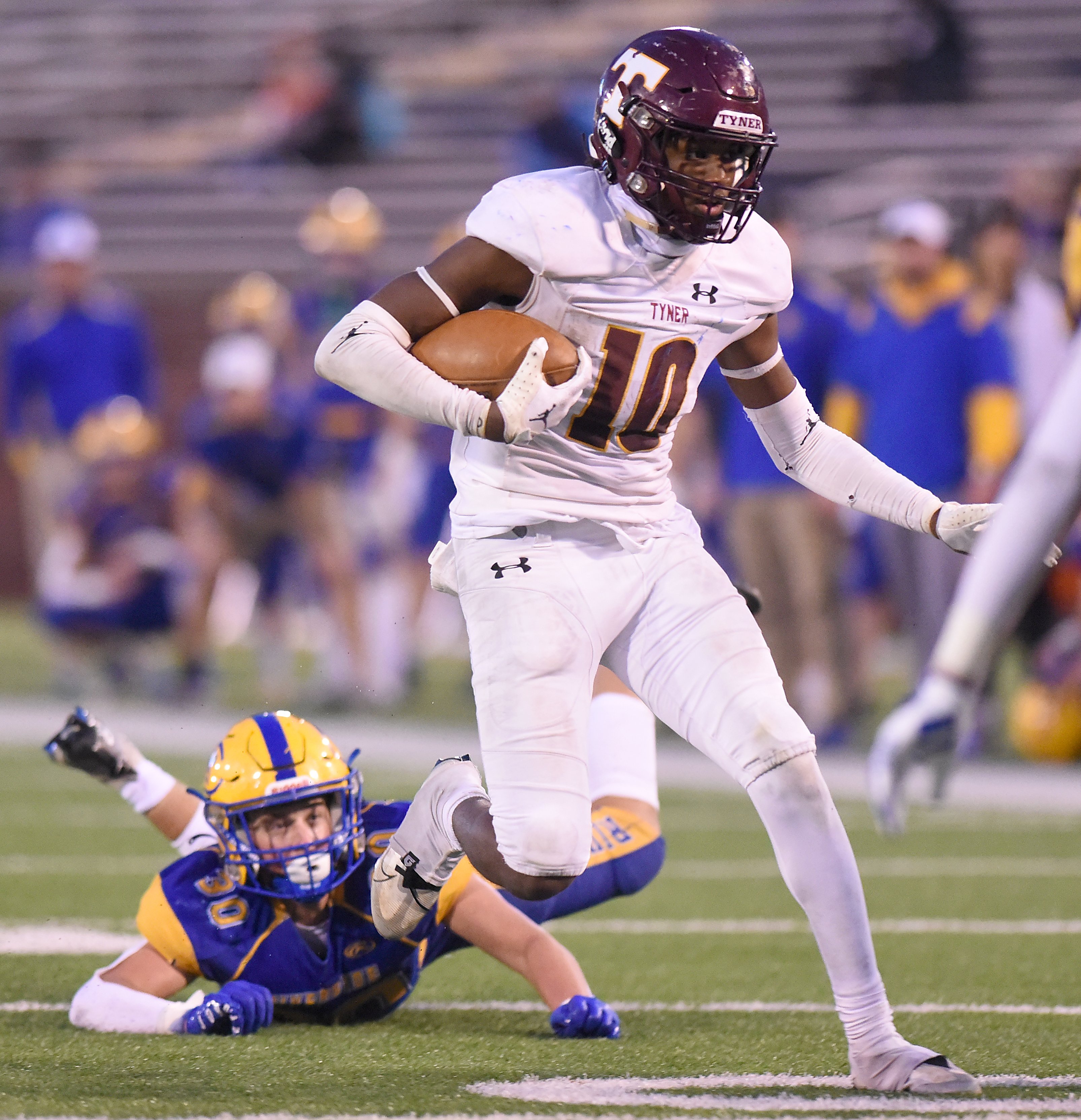 Staff Photo by Matt Hamilton / Tyner (10) McKinley Markel evades Riverside (30) Aiden Creasey on his way to a touchdown during the Class 2A BlueCross Bowl state championship game at Finley Stadium on Saturday, December 3, 2022.