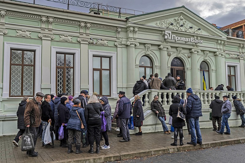 FILE - Residents queue at a bank branch in Kherson, southern Ukraine, Nov. 21, 2022. (AP Photo/Bernat Armangue, File)