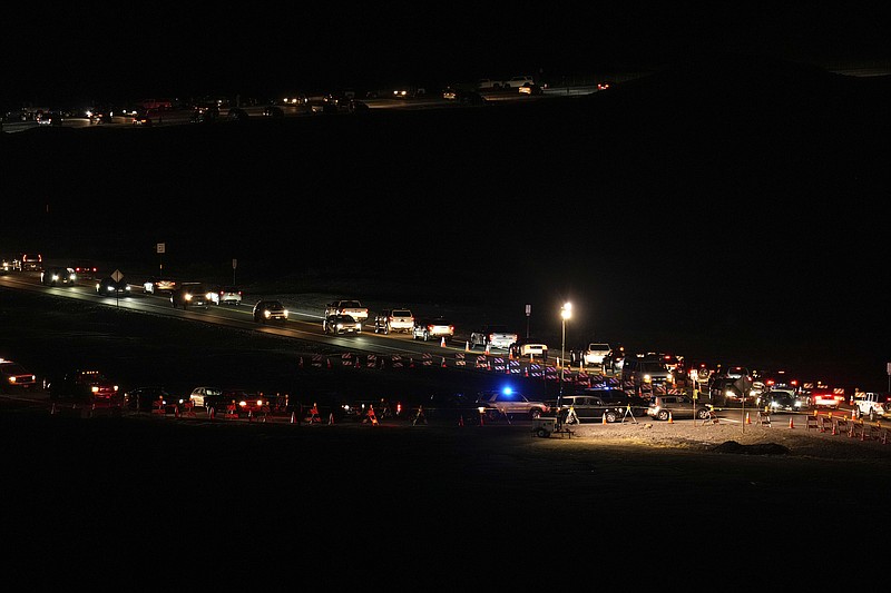 Cars wait in traffic along Saddle Road, with occupants waiting to view the Mauna Loa volcano Thursday, Dec. 1, 2022, near Hilo, Hawaii. (AP Photo/Gregory Bull)