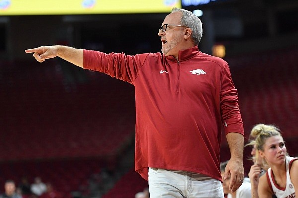 Arkansas Coach Mike Neighbors directs his players on the floor during an exhibition against Arkansas-Fort Smith on Nov. 2, 2022, in Bud Walton Arena in Fayetteville.