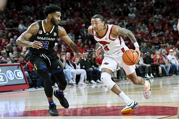Arkansas guard Nick Smith Jr. (3) tries to get past San Jose State forward Sage Tolbert III (12) during the second half of an NCAA college basketball game Saturday, Dec. 3, 2022, in Fayetteville, Ark. (AP Photo/Michael Woods)