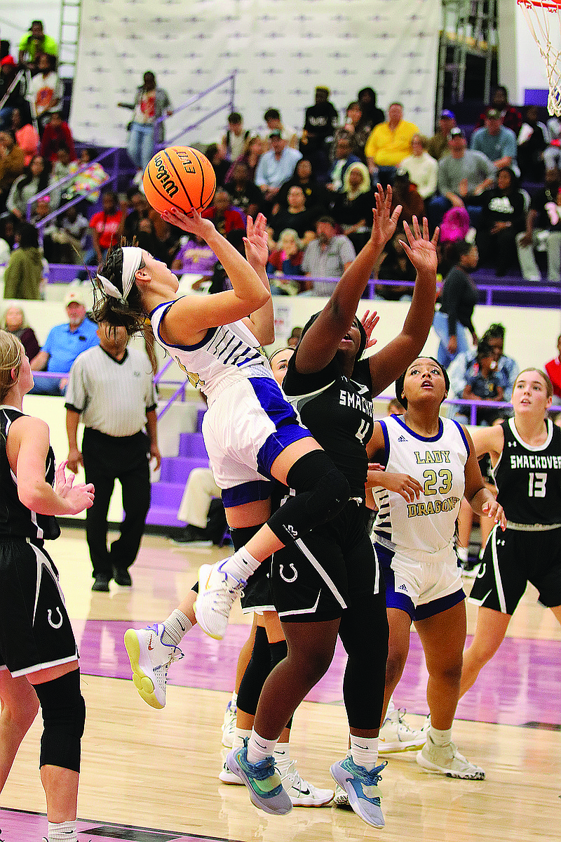 Junction City's Karla Castillo tries to score over Smackover's Jasmin Nelson. The Lady Dragons open conference play at Ouachita on Tuesday. The Lady Bucks travel to Drew Central.