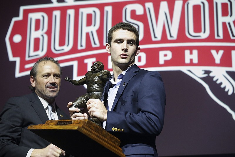 Marty Burlsworth (from left) takes a picture with Burlsworth Award winner Stetson Bennett IV, Monday, December 5, 2022 during the Burlsworth Award presentation at Crystal Bridges Museum in Bentonville Visit nwaonline.com/photo for today's photo gallery...(NWA Democrat-Gazette/Charlie Kaijo)