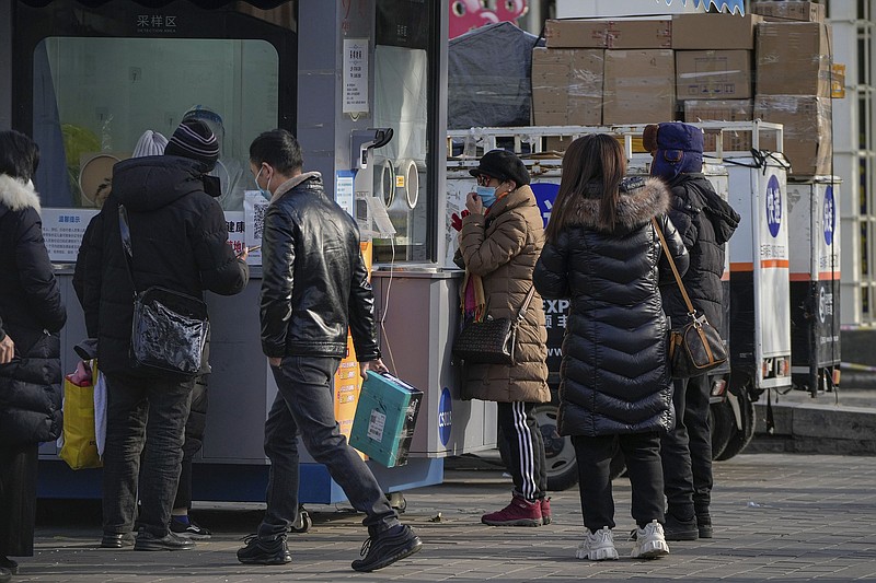 Residents wait in line for their routine covid-19 throat swabs in Beijing on Wednesday.
(AP/Andy Wong)