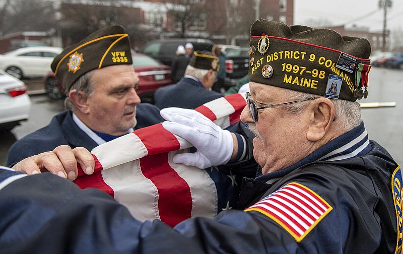 VFW Post 3335 members in Jay, Maine, Ricky Merrill (left) and John Dube fold the American flag on Wednesday afternoon after a Pearl Harbor Remembrance Day ceremony in Livermore Falls, in Androscoggin County, Maine.
(AP/Sun Journal/Russ Dillingham)