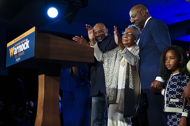 Sen. Raphael Warnock’s mother, Verlene Warnock, and his daughter Chloe join him at his election victory party Tuesday night in Atlanta. Warnock’s victory in swing-state Georgia gives Democrats a welcome “lift,” Senate Majority Leader Charles Schumer said Wednesday.
(AP/John Bazemore)