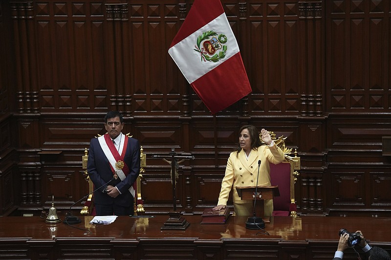 Former Vice President Dina Boluarte takes the oath of office next to Congress President Jose Williams on Wednesday during her swearing-in ceremony to become president in Lima, Peru.
(AP/Guadalupe Pardo)