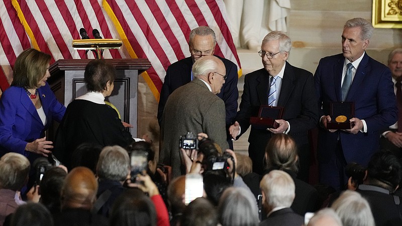 Charles and Gladys Sicknick, father and mother of the late U.S. Capitol Police Officer Brian Sicknick, are greeted by Senate Majority Leader Chuck Schumer of N.Y., center, with Senate Minority Leader Mitch McConnell of Ky., and House Minority Leader Kevin McCarthy of Calif., at right, during a Congressional Gold Medal ceremony honoring law enforcement officers who defended the U.S. Capitol on Jan. 6, 2021, in the U.S. Capitol Rotunda in Washington, Tuesday, Dec. 6, 2022. The members of the Sicknick family declined to shake hands with McConnell and McCarthy. At left is U.S. Capitol Police Chief Thomas Manger and House Speaker Nancy Pelosi of Calif. (AP Photo/Carolyn Kaster)