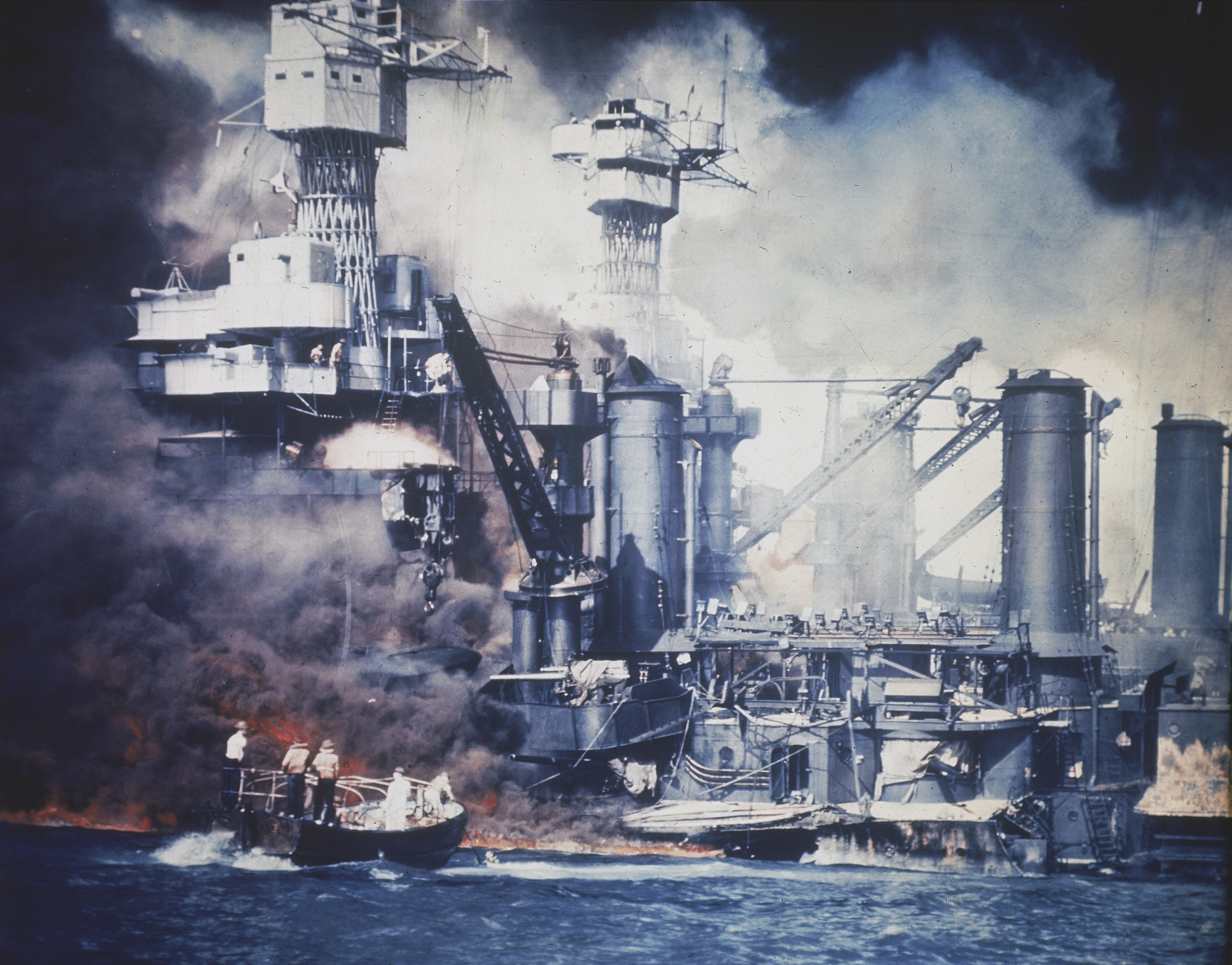 FILE - A small boat rescues a USS West Virginia crew member from the water after the Japanese bombing of Pearl Harbor, Hawaii, on Dec. 7, 1941. A few centenarian survivors of the attack on Pearl Harbor are expected to gather at the scene of the Japanese bombing on Wednesday, Dec. 7, 2022, to remember those who perished 81 years ago. (AP Photo/File)