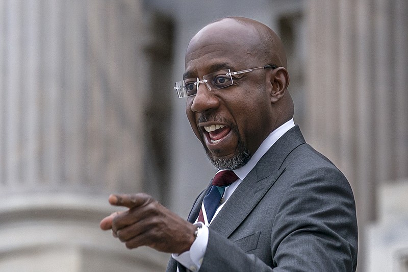 Sen. Raphael Warnock, D-Ga., arrives at the Capitol after defeating Republican challenger Herschel Walker in a runoff election in Georgia last night, in Washington, Wednesday, Dec. 7, 2022. (AP Photo/J. Scott Applewhite)