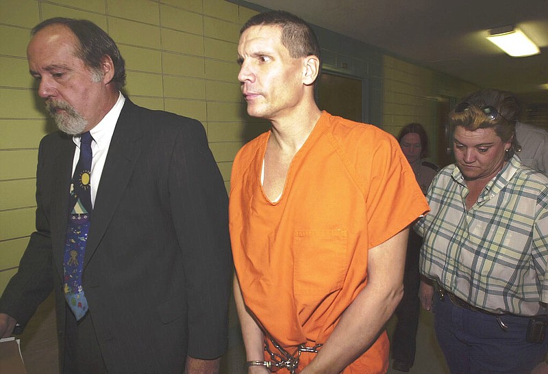 FILE - Scott Eizember, right, is escorted to Angelina County District Court with his lawyer, John Henry Tatum II, on Dec. 3, 2003, in Lufkin, Texas. (Joel Andrews/The Daily News via AP, File)