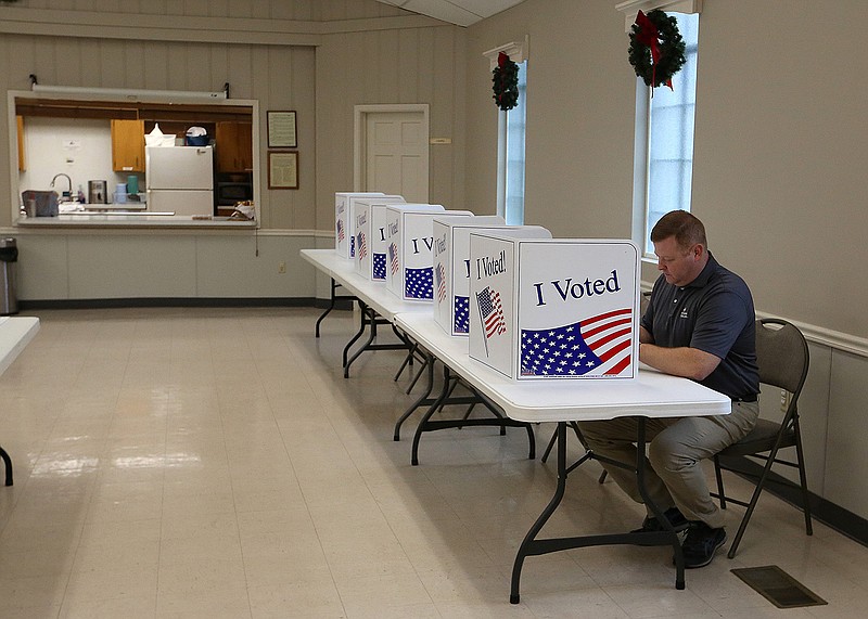 Chris Perry fills out his ballot while voting in the Sherwood mayor's runoff election on Tuesday, Dec. 6, 2022, at Sylvan Hills United Methodist Church in Sherwood. .(Arkansas Democrat-Gazette/Thomas Metthe)