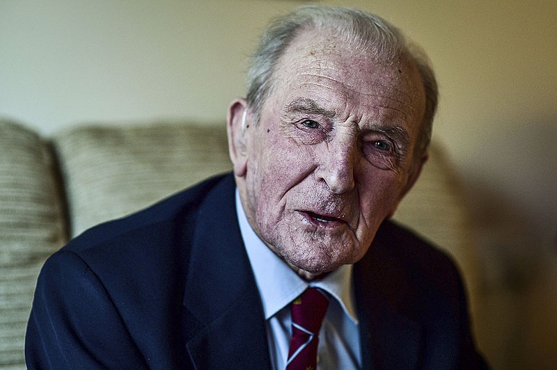 George "Johnny" Johnson, then aged 95, poses for a photo at his home in Bristol, England, Jan. 5, 2017.  Johnson, the last known survivor of Britain’s daring World War II “Dambusters” raid on German infrastructure, has died. He was 101. 
(Ben Birchall/PA via AP, File)