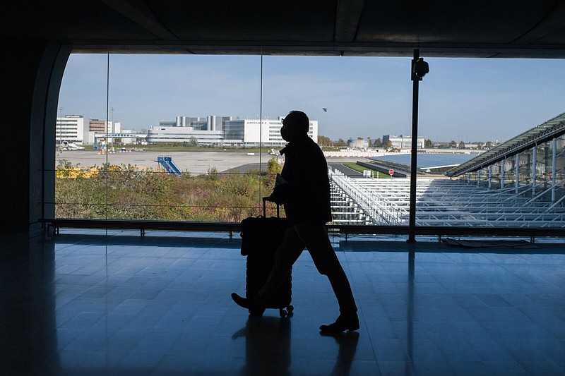 An airline passenger wheels his luggage through Paris-Charles de Gaulle airport in Paris in this file photo.
(Bloomberg News WPNS/Nathan Laine)