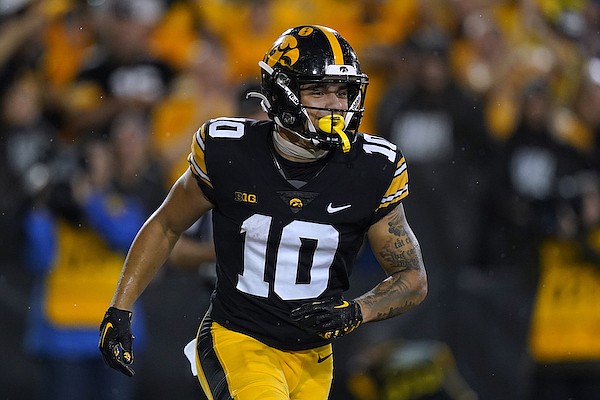 Iowa wide receiver Arland Bruce runs off the field after catching a touchdown pass during the first half of an NCAA college football game against Nevada, Saturday, Sept. 17, 2022, in Iowa City, Iowa. (AP Photo/Charlie Neibergall)