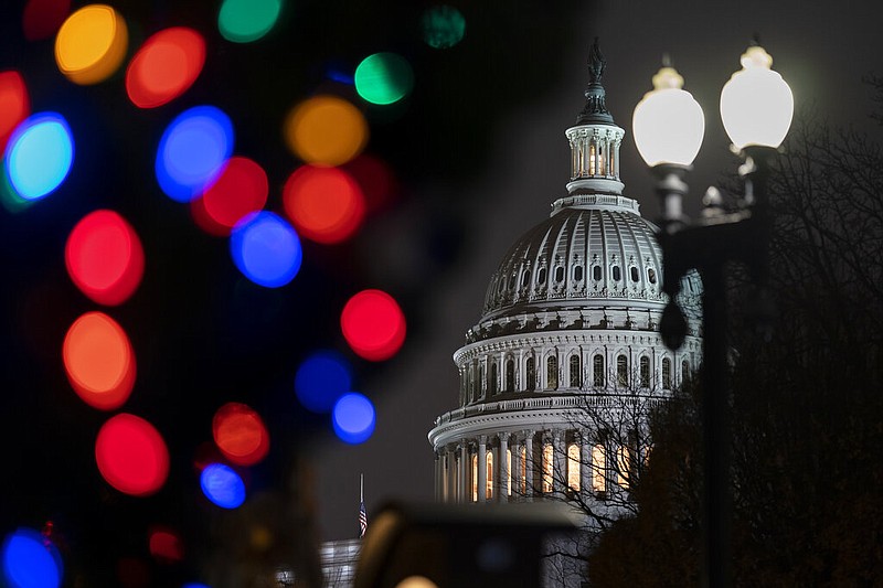 The Capitol is seen amid holiday lights Wednesday evening as the House of Representatives works to approve the Respect for Marriage Act, a bill already passed in the Senate to codify both interracial and same-gender marriage, in Washington, Dec. 7, 2022. (AP Photo/J. Scott Applewhite)