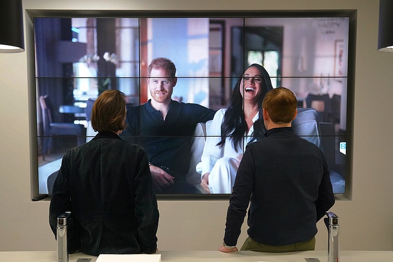 Office workers in London, watch the Duke and Duchess of Sussex's controversial documentary being aired on Netflix Thursday, Dec. 8, 2022. Britainâ€™s monarchy is bracing for more bombshells to be lobbed over the palace gates as Netflix releases the first three episodes of a new series. The show â€œHarry & Meghanâ€ promises to tell the â€œfull truthâ€ about Prince Harry and his wife Meghanâ€™s estrangement from the royal family. The series debuted Thursday. (Jonathan Brady/PA via AP)