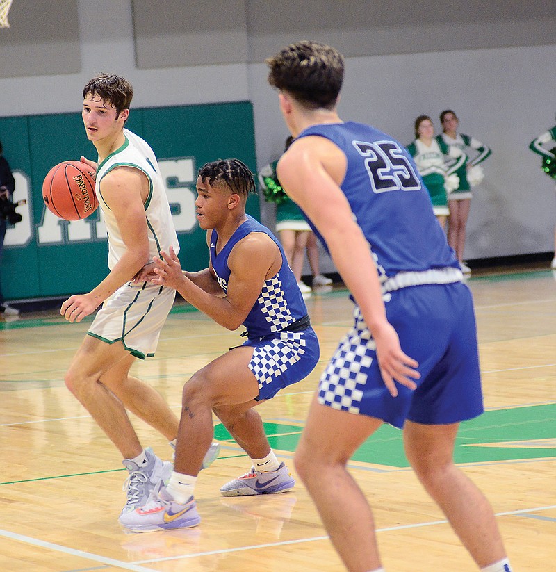 Dylan Hair of Blair Oaks works against the defense of Capital City’s Jaylen Thomas during Wednesday night’s game in Wardsville. (Eileen Wisniowicz/News Tribune)