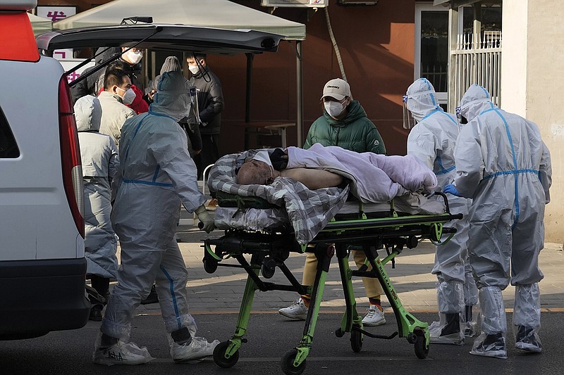 An elderly man on a stretcher is wheeled into the fever clinic at a hospital Friday in Beijing.
(AP/Ng Han Guan)