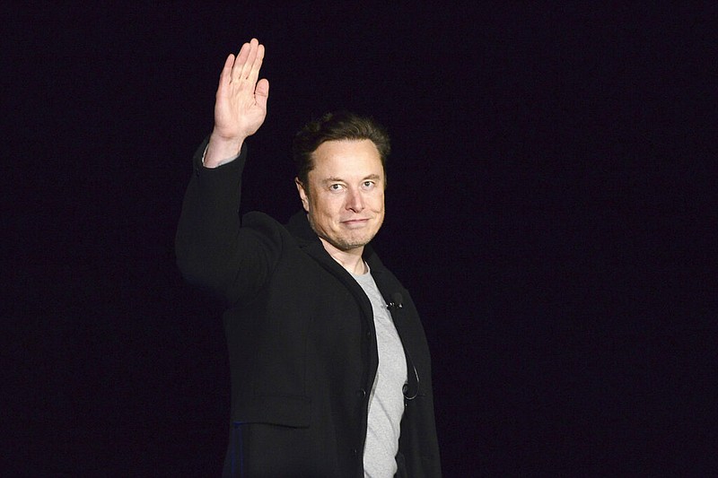 FILE - SpaceX's Elon Musk waves while providing an update on Starship, on Feb. 10, 2022, near Brownsville, Texas. Musk's Twitter has dissolved its Trust and Safety Council, the advisory group of around 100 independent civil, human rights and other organizations that the company formed in 2016 to address hate speech, child exploitation, suicide, self-harm and other problems on the platform. The council had been scheduled to meet with Twitter representatives Monday night, Dec. 12. But Twitter informed the group via email that it was disbanding it shortly before the meeting was to take place, according to multiple members. (Miguel Roberts/The Brownsville Herald via AP, File)