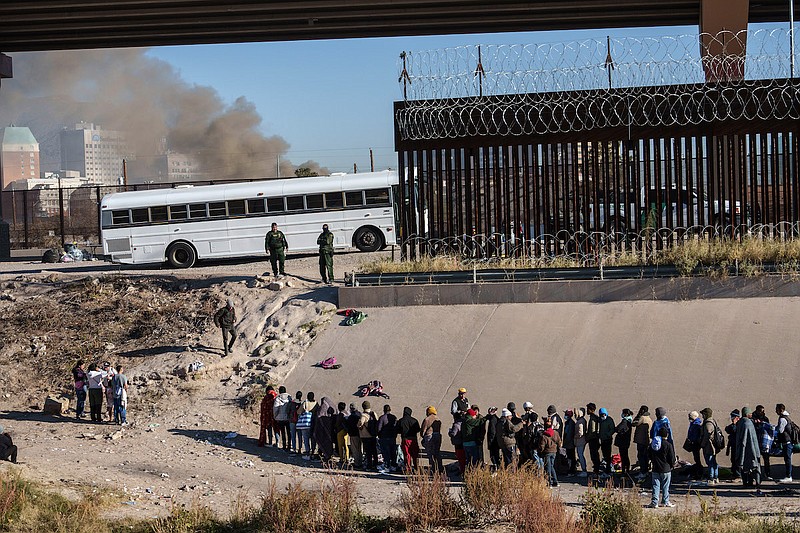 Migrants, mostly from Nicaragua, wait to board a U.S. Customs and Border Protection bus at the U.S.-Mexico border in El Paso, Texas, Dec. 12, 2022. The arrival of up to 1,000 migrants on Sunday, Dec. 11, 2022, was one of the largest single border crossings in recent years in West Texas, which has seen a surge in migration. (Paul Ratje/The New York Times)