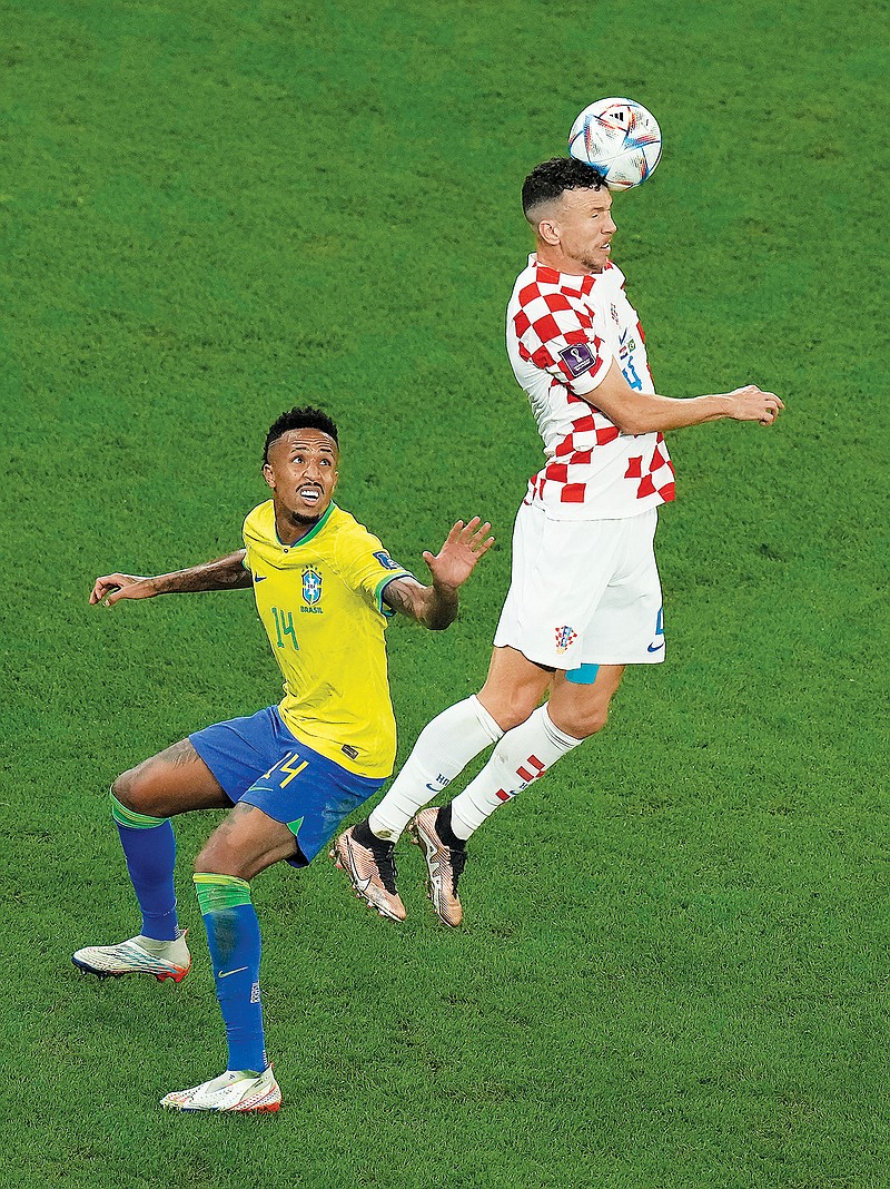 Croatia’s Ivan Perisic goes for a header last Friday above Brazil’s Eder Militao during the World Cup quarterfinal match in Al Rayyan, Qatar. (Associated Press)