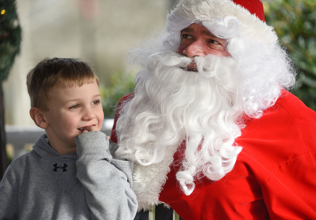 Staff photo by Matt Hamilton / Hunter Forrest, 4, of Rock Spring, Ga., thinks about what he wants for Christmas during his visit with Santa at Joe Stock Memorial Park in LaFayette, Ga. on Saturday, December 17, 2022. The cookies with Santa event was held as a fundraiser for Bridge Health, a community service board that offers adult programs, youth programs, programs for developmentally disabled and more.