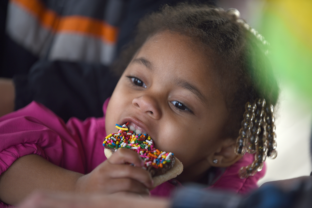 Staff photo by Matt Hamilton / LaFayette resident Chloe Hood, 3, eats a cookie after decorating it herself at Joe Stock Memorial Park in LaFayette, Ga. on Saturday, December 17, 2022. The cookies with Santa event was held as a fundraiser for Bridge Health, a community service board that offers adult programs, youth programs, programs for developmentally disabled and more.