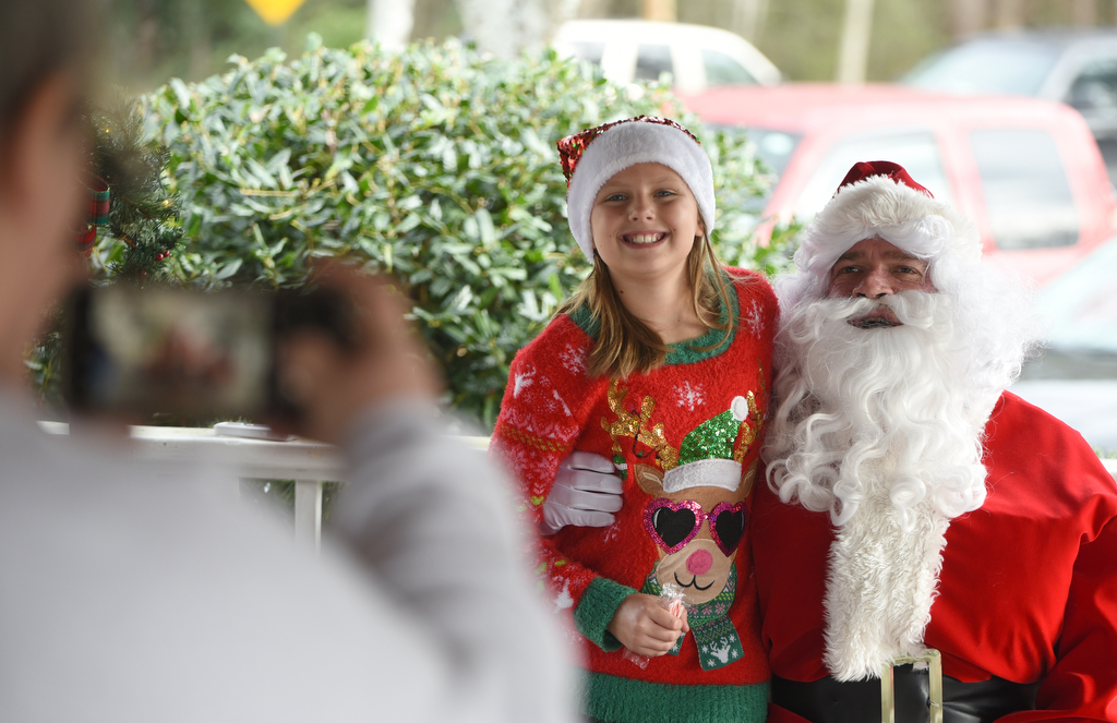 Staff photo by Matt Hamilton / Trion resident Jennifer Dennison takes a picture of her granddaughter Ava Dennison, 9, during her visit with Santa at Joe Stock Memorial Park in LaFayette, Ga. on Saturday, December 17, 2022. The cookies with Santa event was held as a fundraiser for Bridge Health, a community service board that offers adult programs, youth programs, programs for developmentally disabled and more.