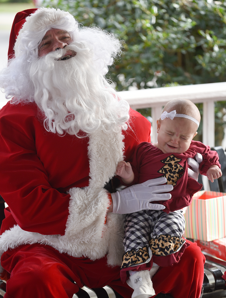 Staff photo by Matt Hamilton / Santa laughs as LaFayette resident Savana Wright, 6 mo., reacts while having her picture taken at Joe Stock Memorial Park in LaFayette, Ga. on Saturday, December 17, 2022. The cookies with Santa event was held as a fundraiser for Bridge Health, a community service board that offers adult programs, youth programs, programs for developmentally disabled and more.