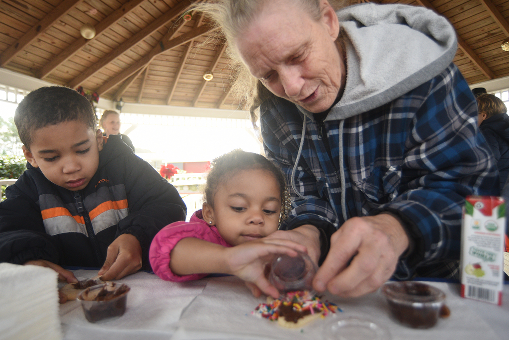 Staff photo by Matt Hamilton / Betsy Caster, right, helps Shaun Hood, 5, and Chloe Hood, 3, decorate cookies at Joe Stock Memorial Park in LaFayette, Ga. on Saturday, December 17, 2022. The cookies with Santa event was held as a fundraiser for Bridge Health, a community service board that offers adult programs, youth programs, programs for developmentally disabled and more.