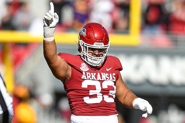 Arkansas defensive lineman Isaiah Nichols celebrates a tackle during a game against LSU on Saturday, Nov. 12, 2022, in Fayetteville.