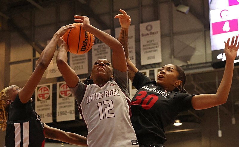 Tia Harvey (12) drives to the basket for UALR during a game against ASU at the Jack Stephens Center on Sunday, Dec. 18, 2022. See more photos at arkansasonline.com/1219bball/ (Arkansas Democrat-Gazette/Colin Murphey)