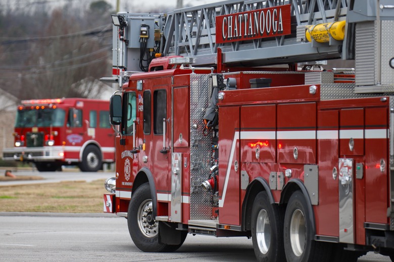 Staff photo by Olivia Ross  / Emergency vehicles sit in the Ooltewah Middle School parking lot near the railroad tracks on Tuesday, December 20, 2022 following a train derailment in Collegedale.