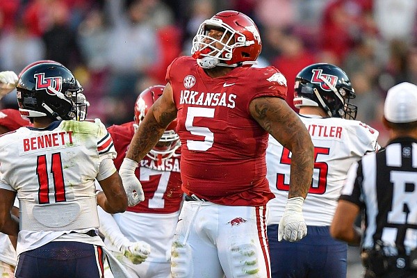 Arkansas defensive lineman Cameron Ball reacts after tackling Liberty quarterback Johnathan Bennett on Saturday, Nov. 5, 2022, during the fourth quarter of the Razorbacks’ 21-19 loss to the Flames at Reynolds Razorback Stadium in Fayetteville.