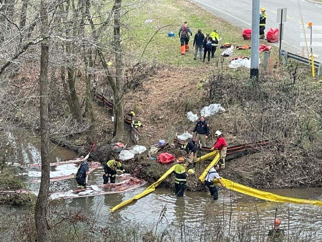 Authorities use absorbent booms and pads to assist with a large diesel spill for the three locomotives that were derailed in Collegedale, Tennessee, on Dec. 20, 2022. / Photo provided by Hamilton County Office of Emergency Management