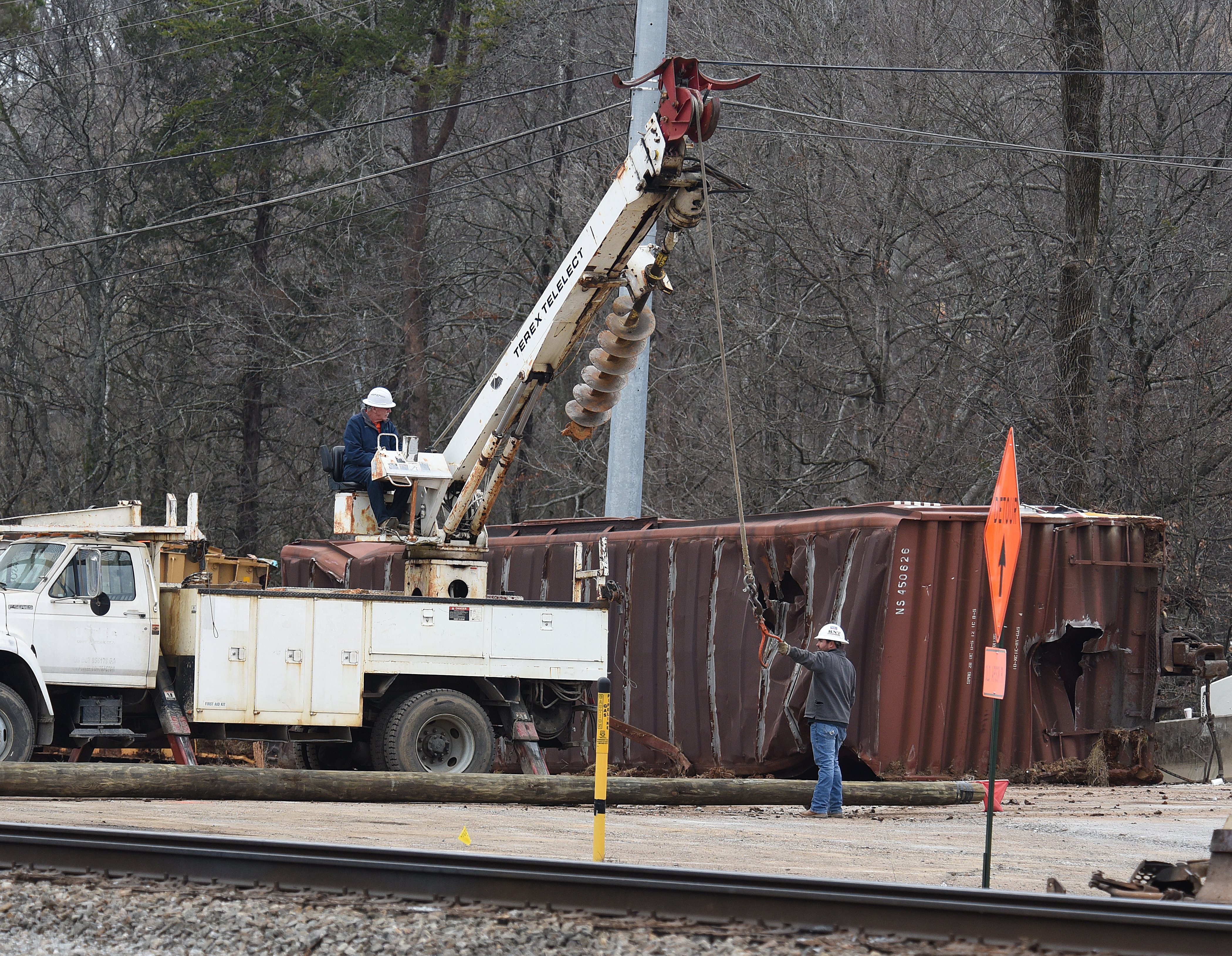 Staff photo by Matt Hamilton / Workers use an augur to dig holes at the site of the train derailment at the intersection of the tracks with Apison Pike on Wednesday, December 21, 2022.