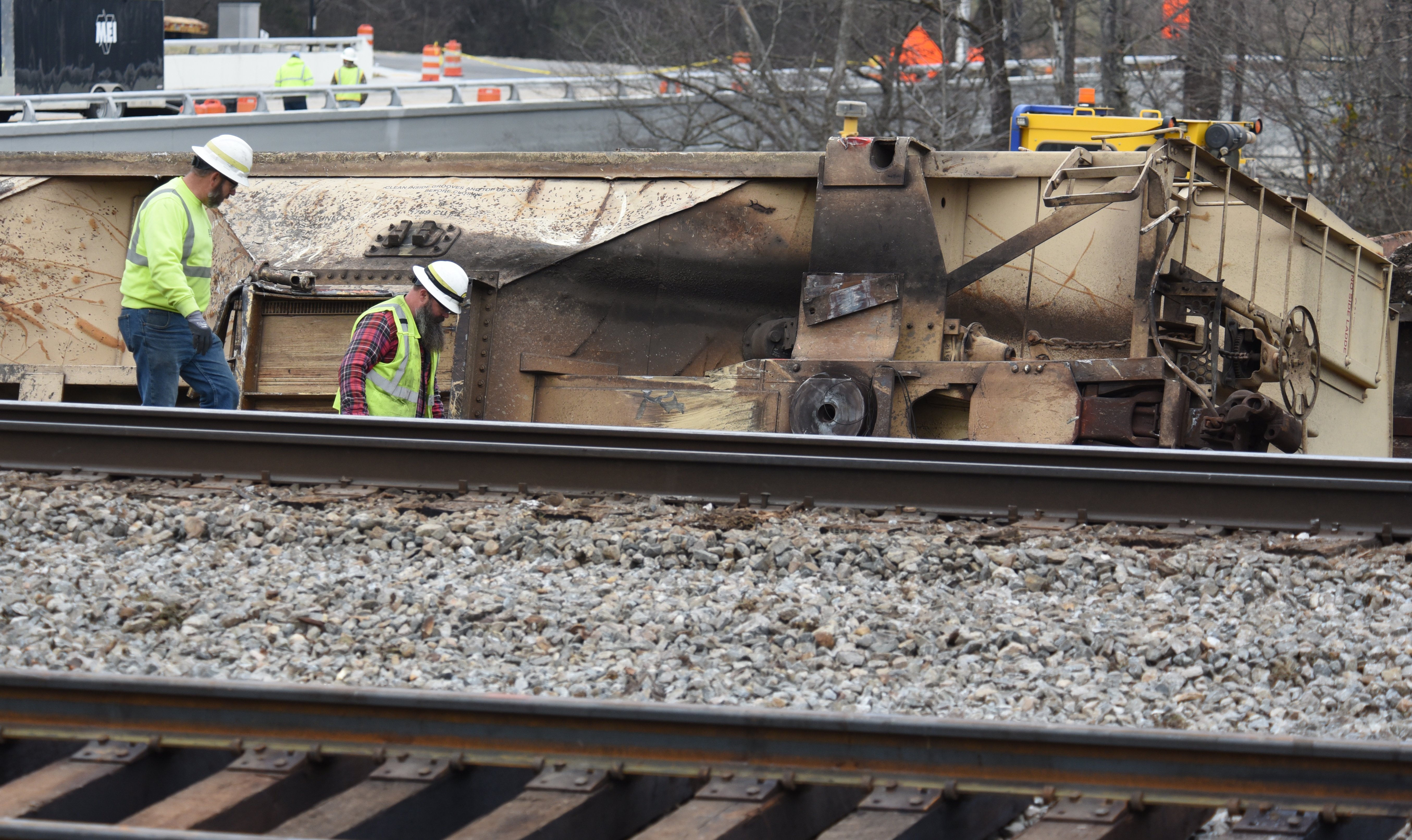 Staff photo by Matt Hamilton / Workers walk along the tracks at the site of the train derailment at the intersection of the tracks with Apison Pike on Wednesday, December 21, 2022.
