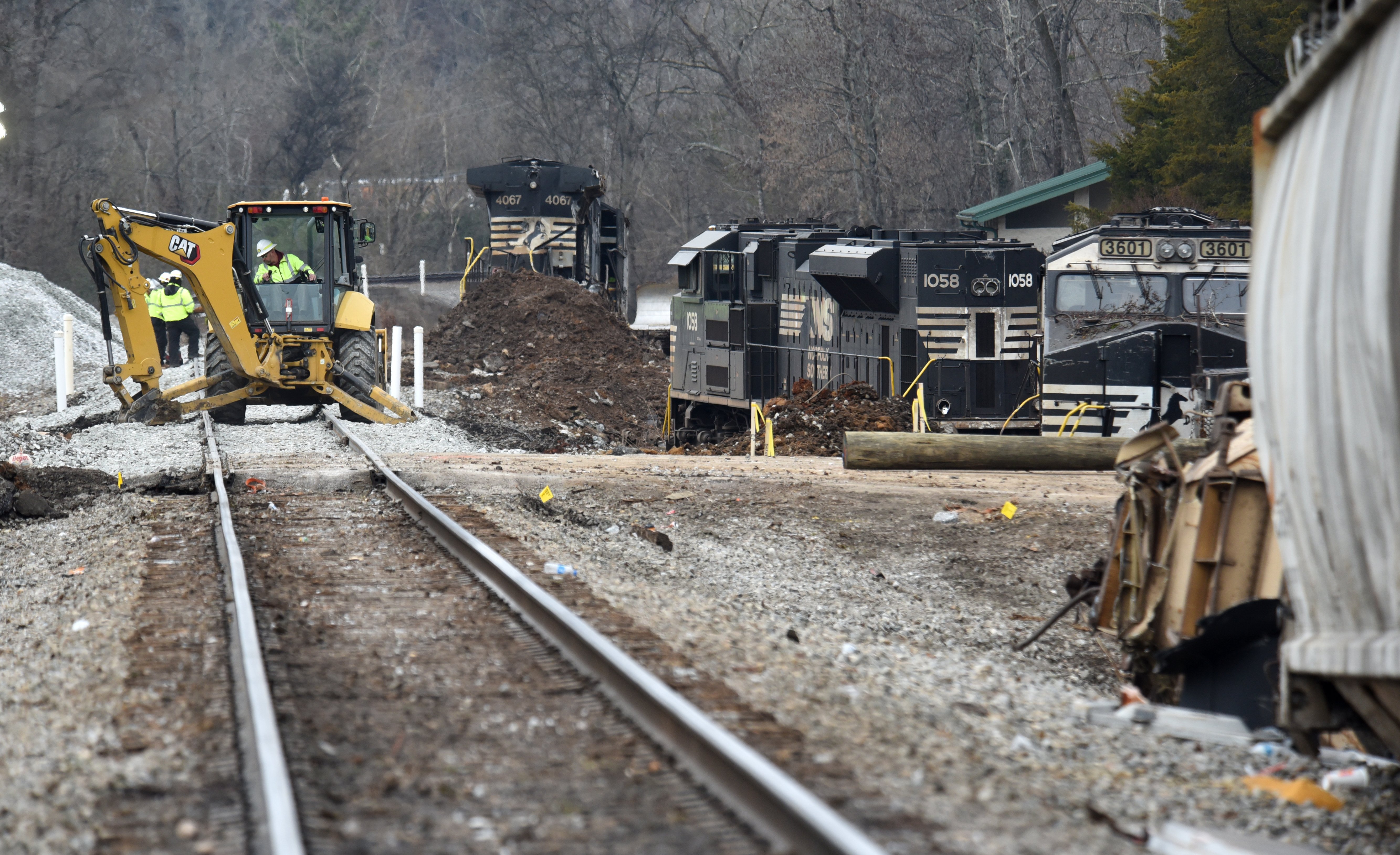 Staff photo by Matt Hamilton / Locomotives rest along the side of the tracks as workers repair the tracks at the site of the train derailment at the intersection of the tracks with Apison Pike on Wednesday, December 21, 2022.