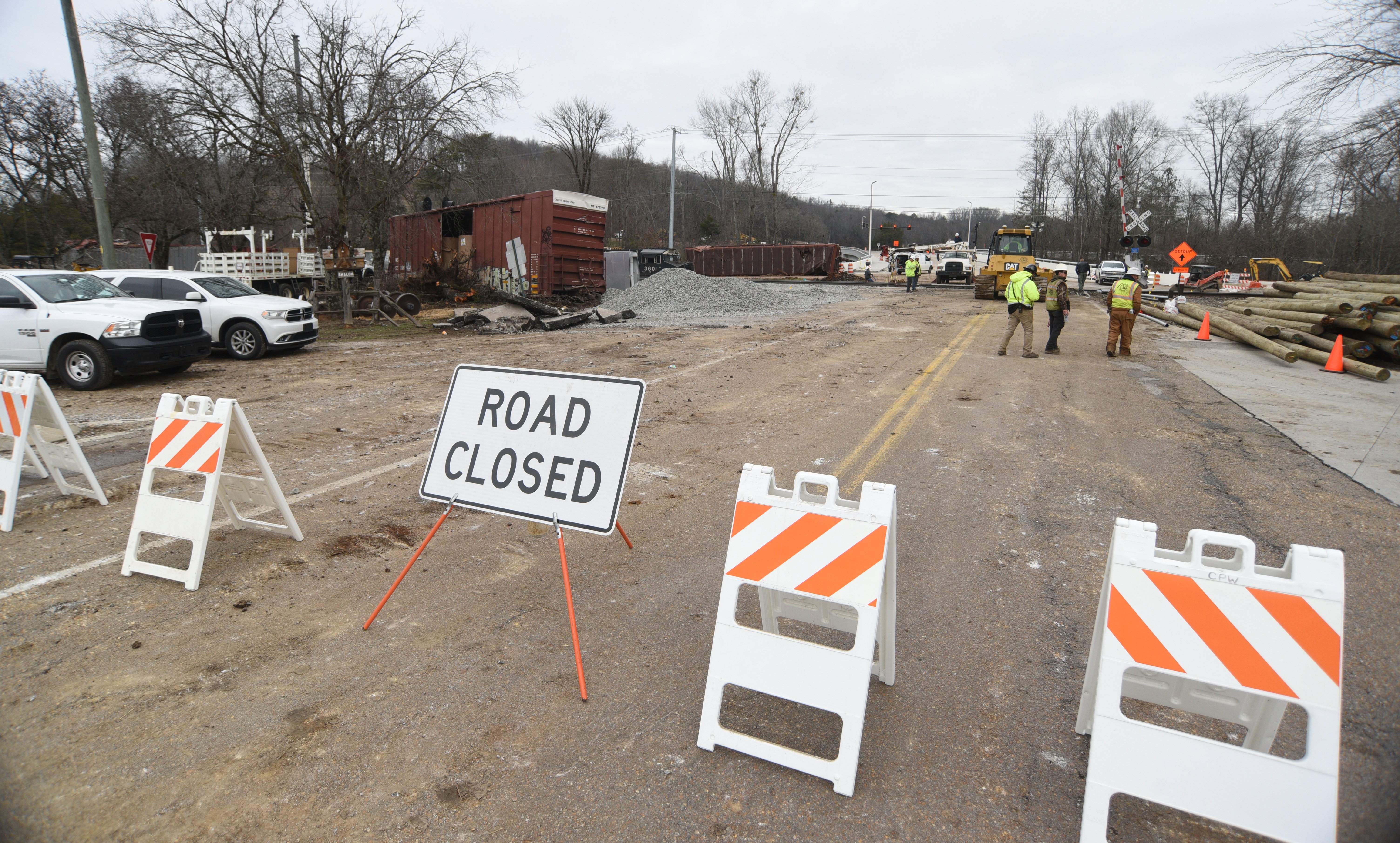 Staff photo by Matt Hamilton / A sign across Apison Pike indicates the road is closed as workers repair the tracks at the site of the train derailment at the intersection of the tracks with Apison Pike on Wednesday, December 21, 2022.