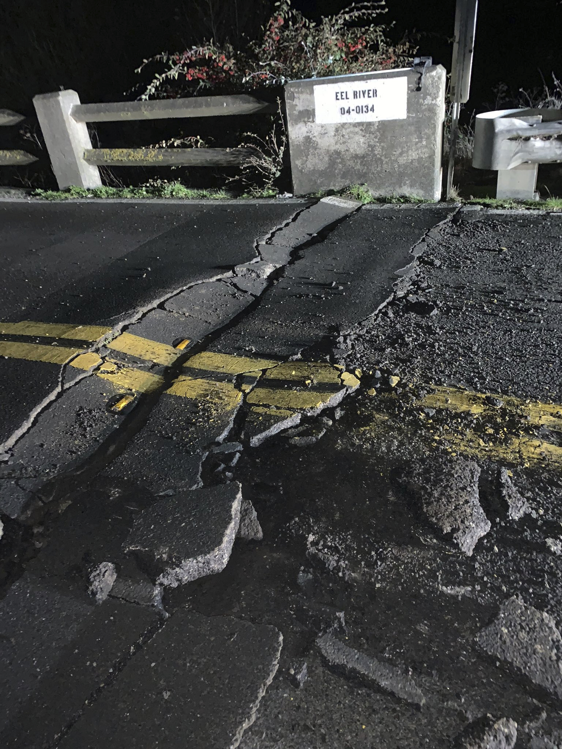 This image posted by Caltrans District 1 shows a road closure on California State Route 211 at Fernbridge, a 1,320-foot-long (402.3 m) concrete arch bridge that spans the Eel River near Fortuna, Calif., in Humboldt County. The bridge is closed while they conduct a safety inspection checking for possible seismic damage. Officials say a strong earthquake in Northern California has cut off power to thousands and damaged roads and homes. No injuries have been reported in the magnitude 6.4 earthquake early Tuesday near Ferndale. That's a small community over 200 miles northwest of San Francisco and close to the Pacific Coast. (Caltrans District 1 via AP)