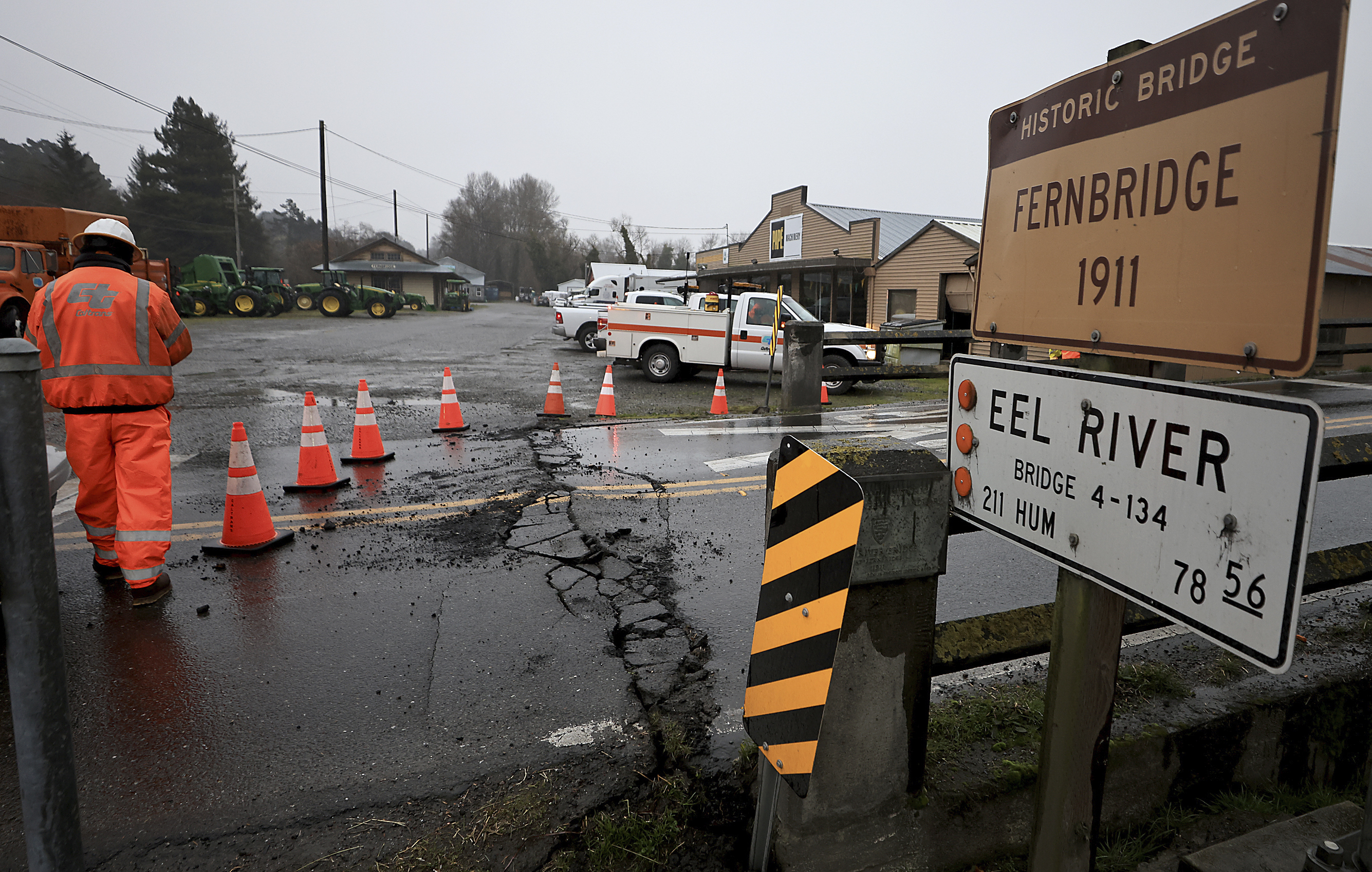 Caltrans workers inspect Fernbridge, the main arterial that connects Ferndale over the Eel River, after an earthquake near Fortuna, Calif., Tuesday, Dec. 20, 2022. (Kent Porter/The Press Democrat via AP)