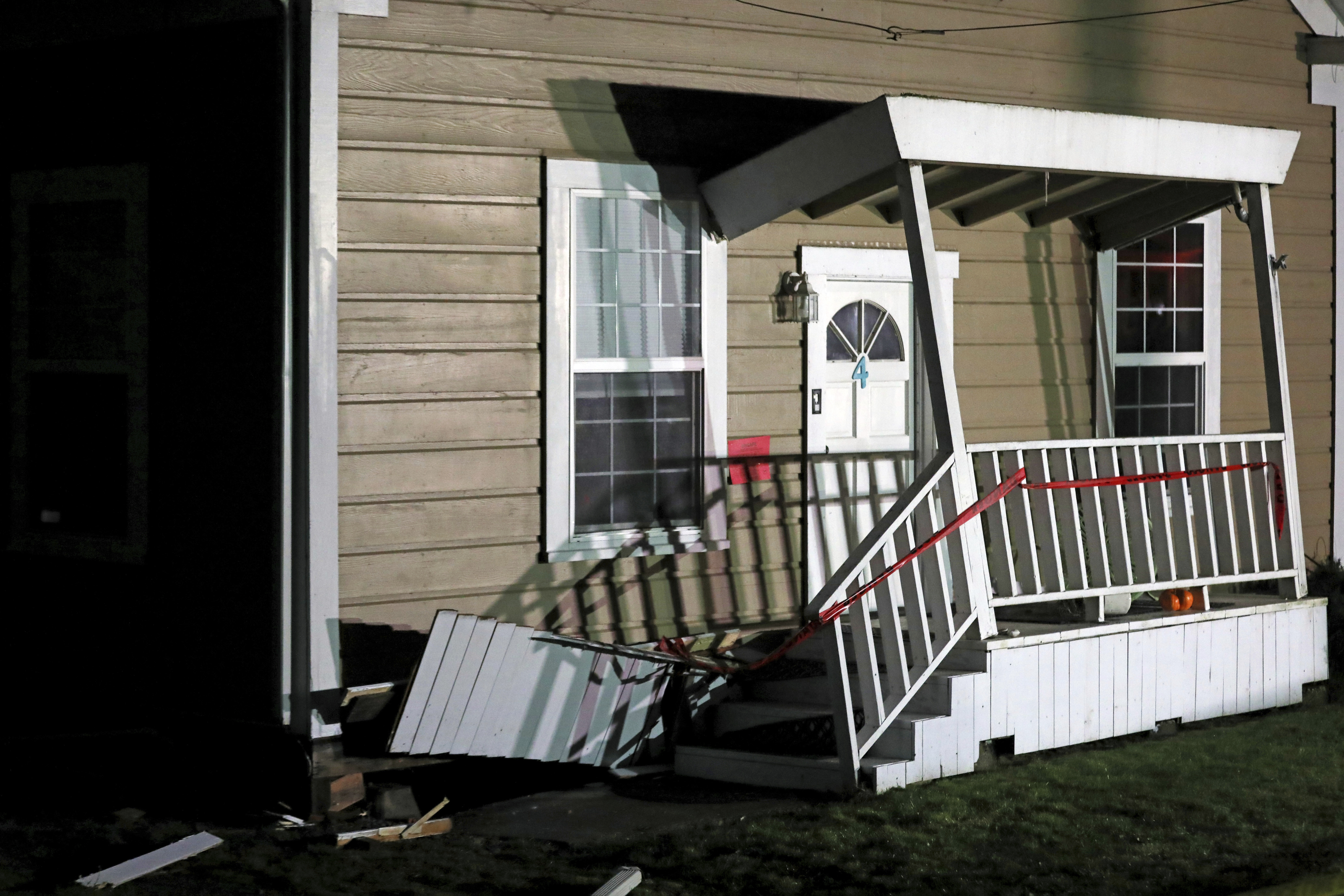 Caution tape is strung on the porch of a damaged home following an earthquake in Rio Dell, Calif., Tuesday, Dec. 20, 2022. (Santiago Mejia/San Francisco Chronicle via AP)