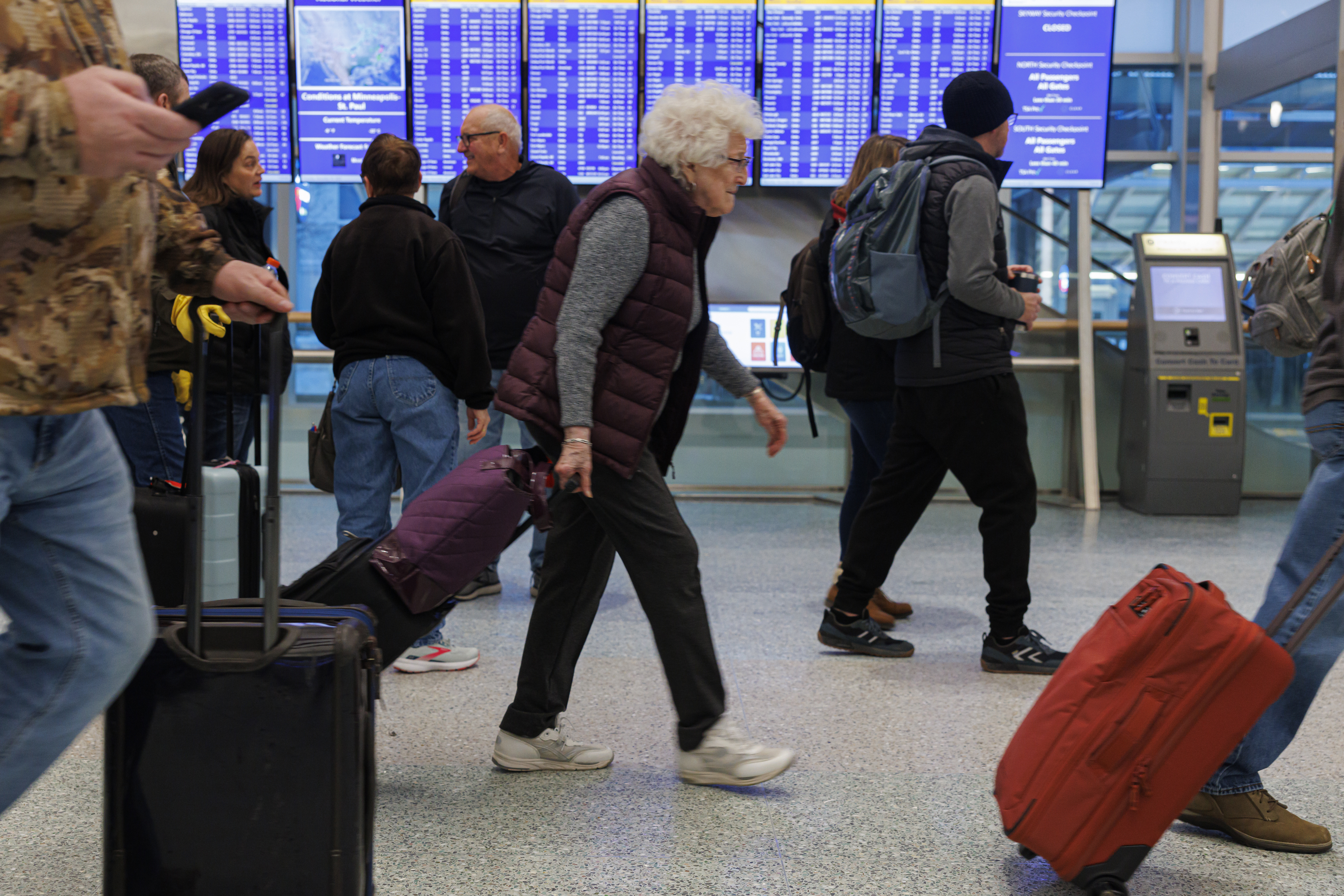 Travelers arrive for their flights at Terminal 1 ahead of the Christmas Holiday at MSP Airport in Bloomington, Minn., on Thursday, Dec. 22, 2022. (Kerem Yücel /Minnesota Public Radio via AP)